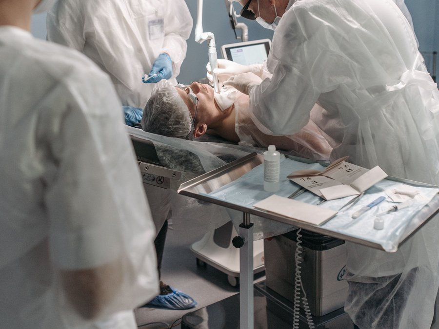 Medical team performing a cosmetic treatment procedure